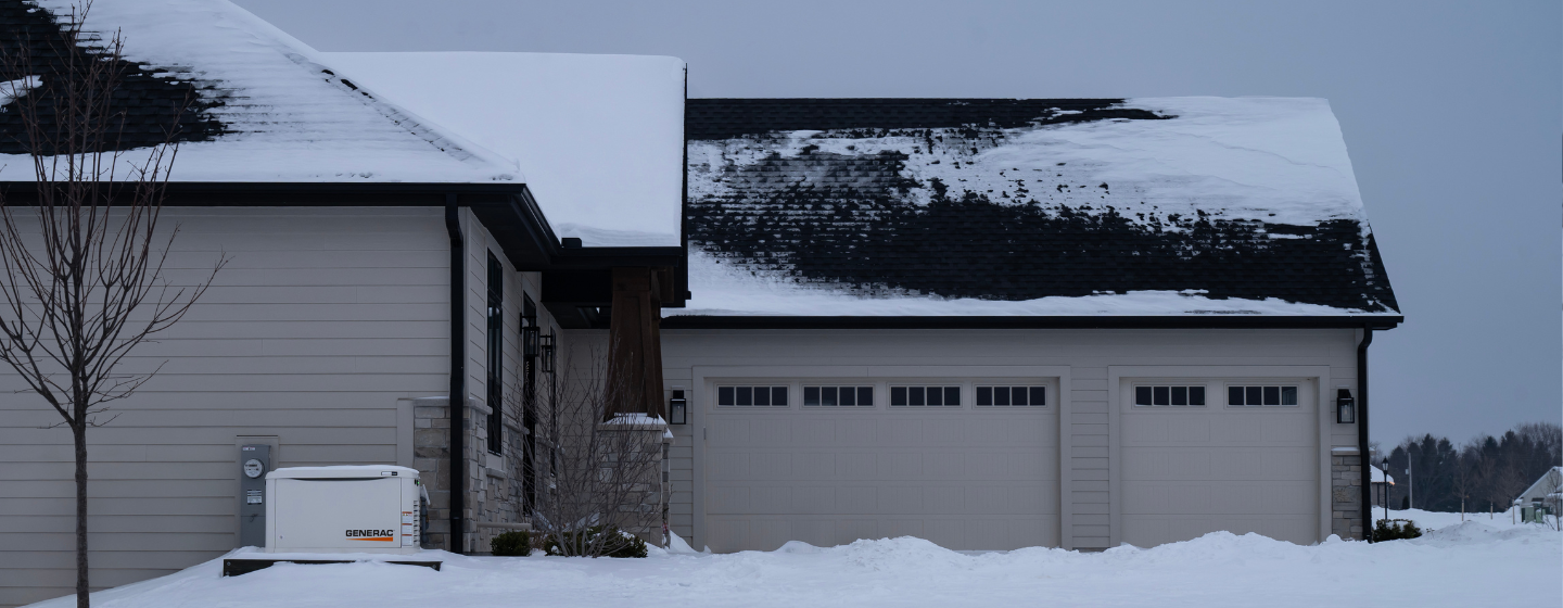 log home with lights on surrounded in snow on a starry night